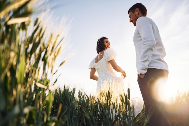 Happy people Couple just married Together on the majestic agricultural field at sunny day