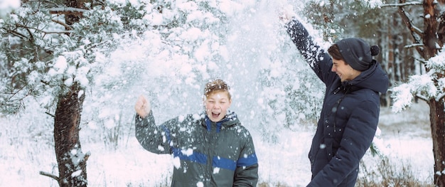 Happy people have fun and play with snow outdoors in winter nature Family Christmas walk in a snowy park at a ski