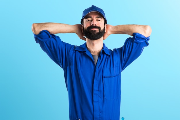 Happy plumber man on colorful background