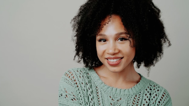 Happy Portrait of a beautiful Young Afro appearance and curly hair The woman is dressed