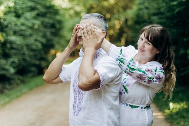 Happy portrait of loving couple on a walk in the park on a sunny day