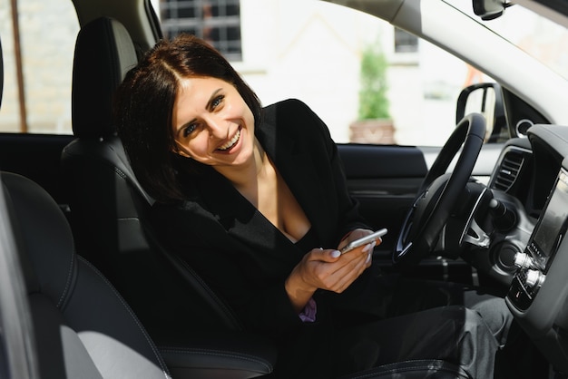 Happy positive woman smiling while using the phone