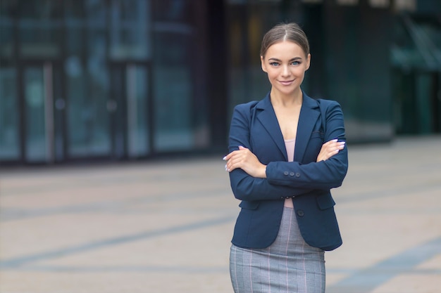 Happy positive young businesswoman in formal suit