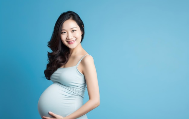 happy pregnant asian woman touching her belly