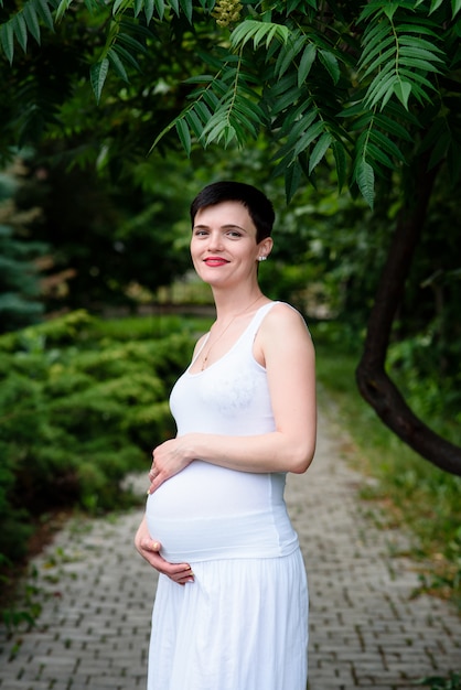 Happy pregnant family in the Park.