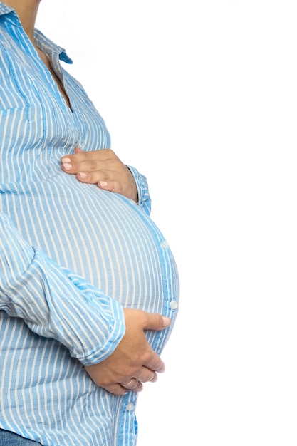 Happy pregnant girl lies on white background