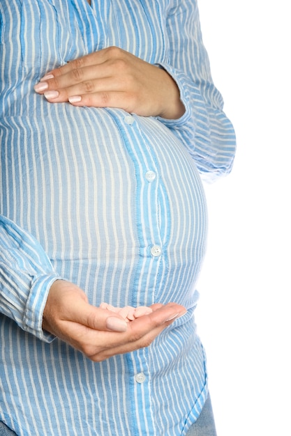 Happy pregnant girl lies on white background