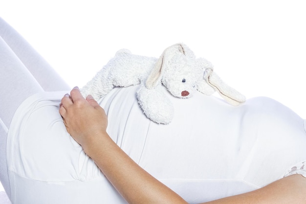 Happy pregnant girl lies on white background