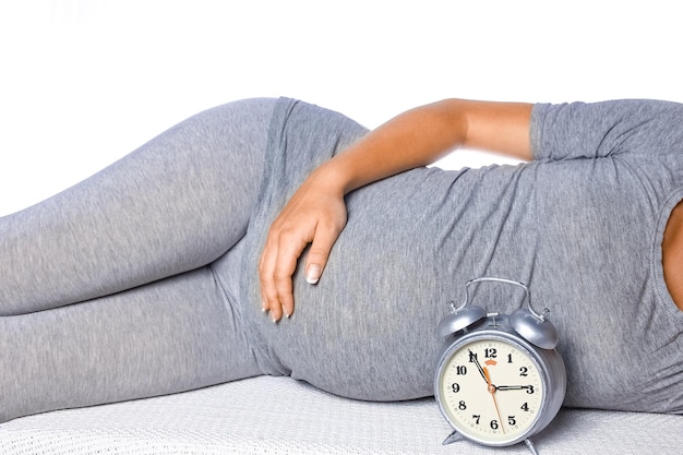 Happy pregnant girl lies on white background