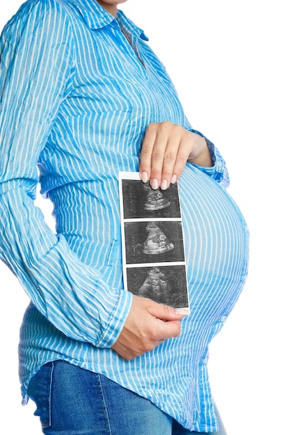 Happy pregnant girl lies on white background