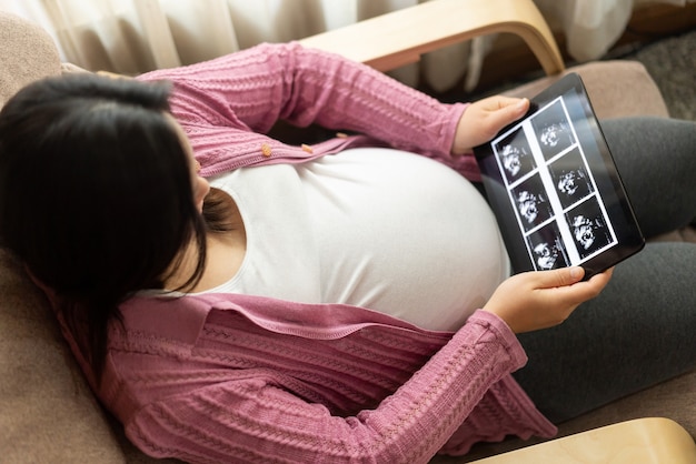 Happy pregnant woman and expecting baby.