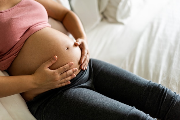 Happy pregnant woman and expecting baby.