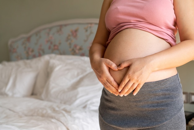 Happy pregnant woman and expecting baby.