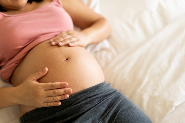 Happy pregnant woman and expecting baby.