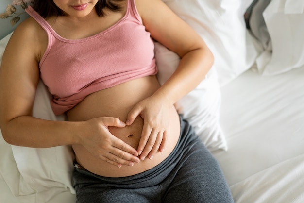 Happy pregnant woman and expecting baby.