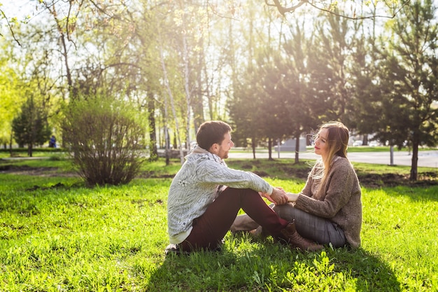 Happy pregnant woman and her husband in the park.