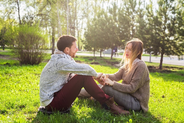 Happy pregnant woman and her husband in the park.