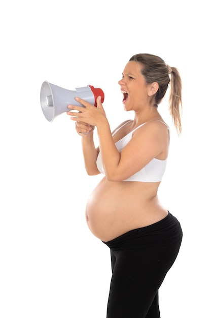 Happy pregnant woman stroking keeping hands on big belly stomach tummy with baby scream in megaphone