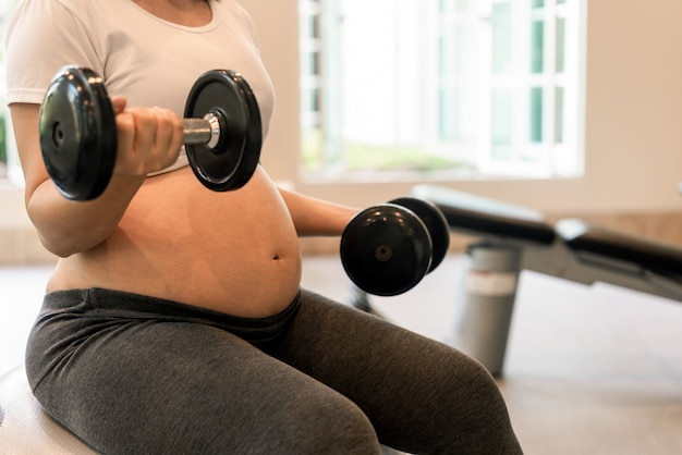 Happy pregnant woman with baby in pregnant belly