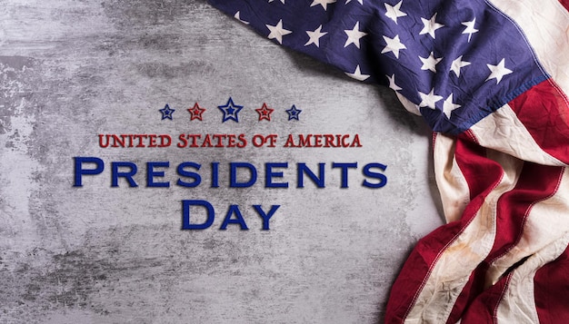 Happy presidents day concept with flag of the United States on dark stone background.