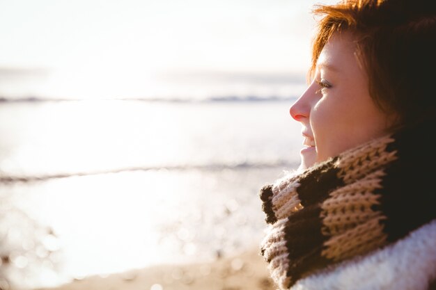 Happy pretty brunette looking at the sea 