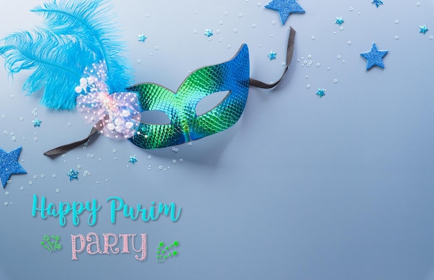 Happy Purim carnival decoration concept made from mask and sparkle star and hamantaschen cookies on pastel background Happy Purim in Hebrew jewish holiday celebrate