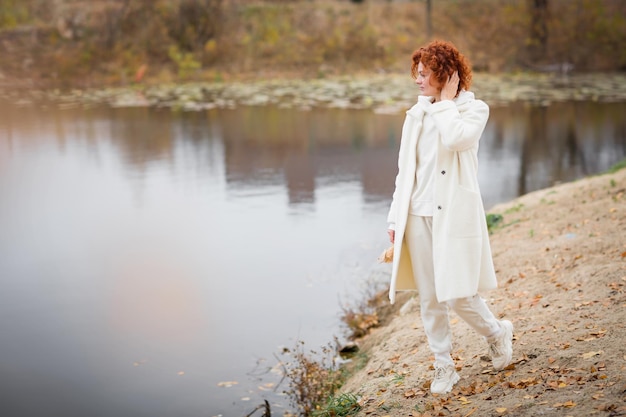 Happy redhair woman in white clothes