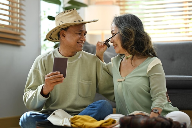 Happy retired couple packing cloth and stuff getting ready for summer vacation Traveling in retirement concept