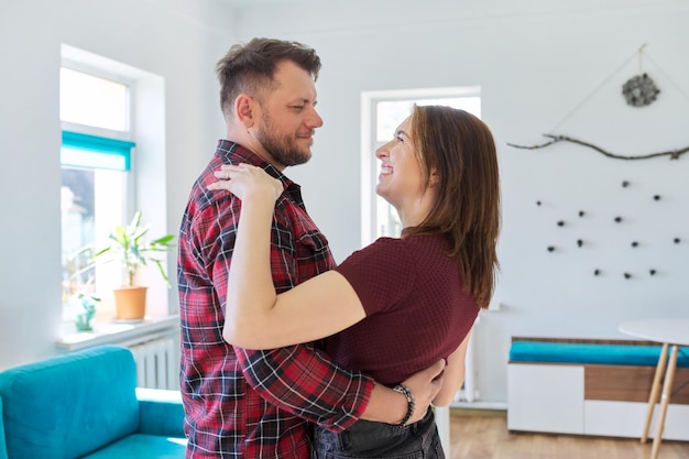 Happy romantic middle aged couple in love dancing