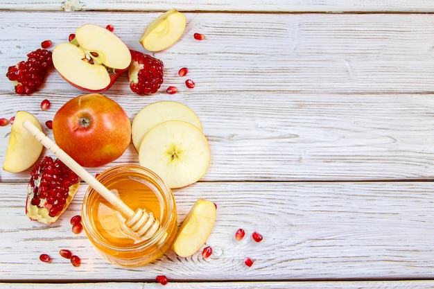 Happy Rosh Hashanah Traditional symbols of Jewish New Year celebration Apples pomegranates and honey