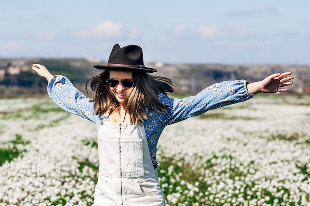 Happy running woman in flower field