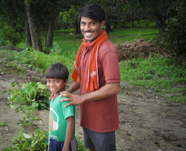 Happy rural Indian farmer with son