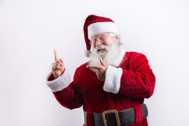 Happy Santa Claus, pointing a side in white wall