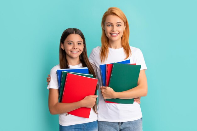 Happy school pupil and student holding workbooks school