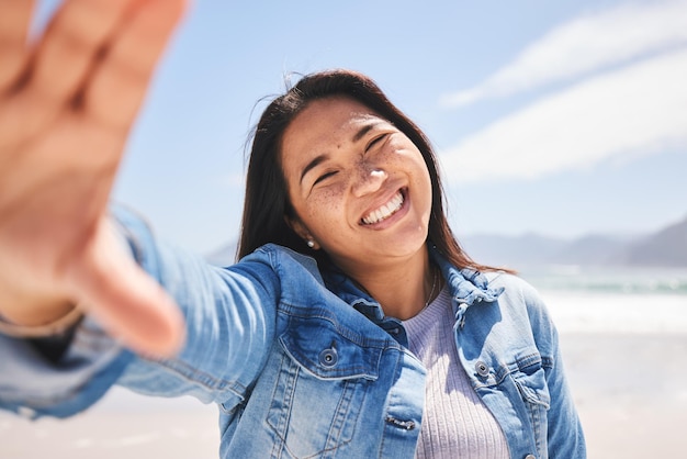 Happy selfie and woman on beach for holiday vacation or summer in Indonesia or profile picture for social media or memory Portrait smile and person at the ocean sea or relax in nature for break