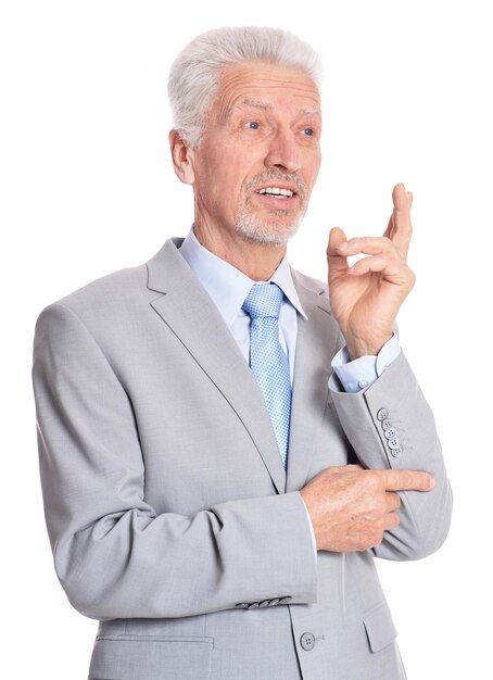 Happy senior businessman posing  on white background