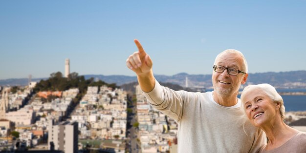 happy senior couple over san francisco city