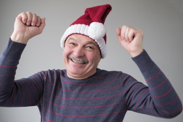 Happy senior hispanic man expressing emotions in good christmas day