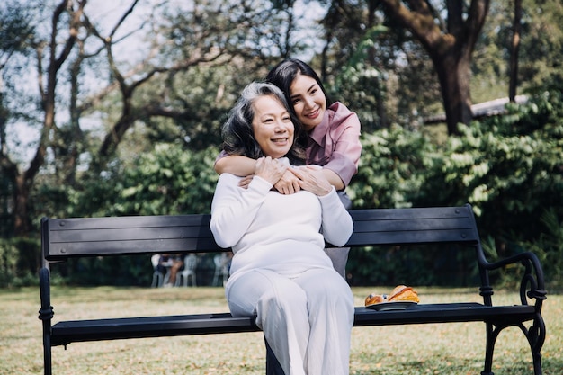 Happy senior woman enjoying in daughter's affection on Mother's day