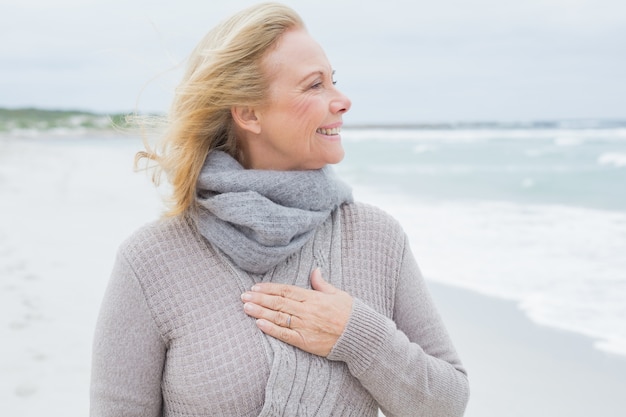 Happy senior woman looking away at beach