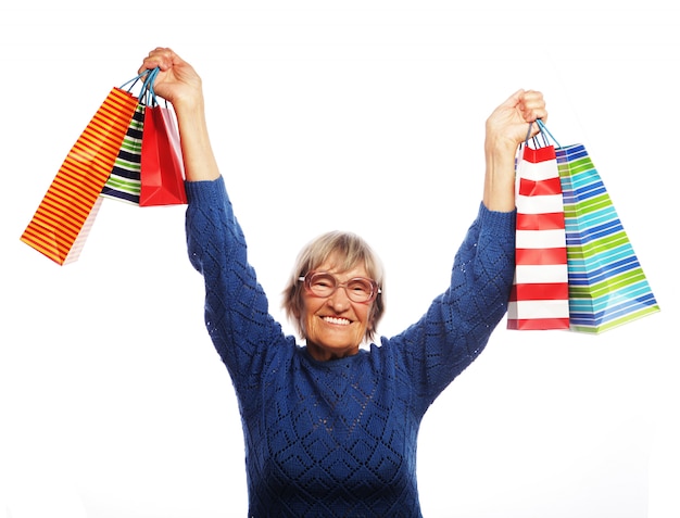 Happy senior woman with shopping bags