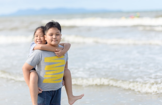 Happy sister riding brother back 