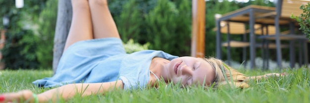 Happy sleeping woman resting on grass tranquility and relaxation concept