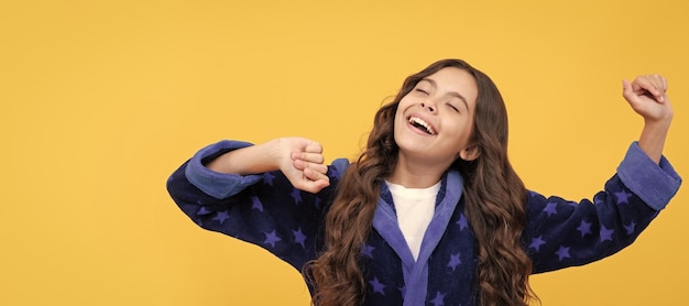 Happy sleepy child girl enjoy morning in cozy bathrobe lazy weekend Child face horizontal poster 