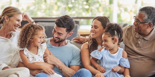 Happy smile and big family on a sofa to relax in the living room together at home Diverse grandparents parents and children from Brazil with happiness love and bonding sitting on a couch