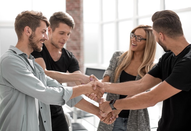 Happy smiling business team standing in a row at office