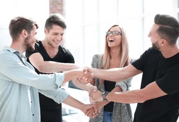 Happy smiling business team standing in a row at office