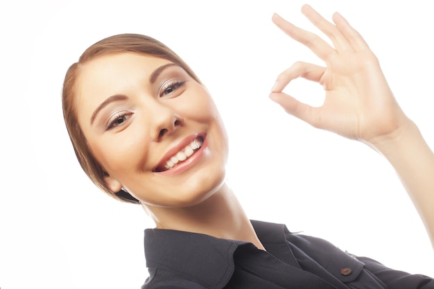 Happy smiling business woman with okay gesture