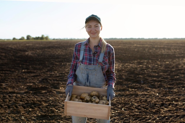 Happy smiling caucasian female potato farmer or gardener Agriculture food production harvest concept