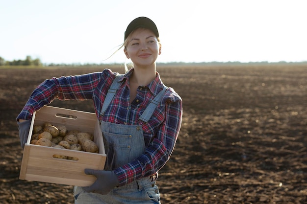 Happy smiling caucasian female potato farmer or gardener Agriculture food production harvest concept